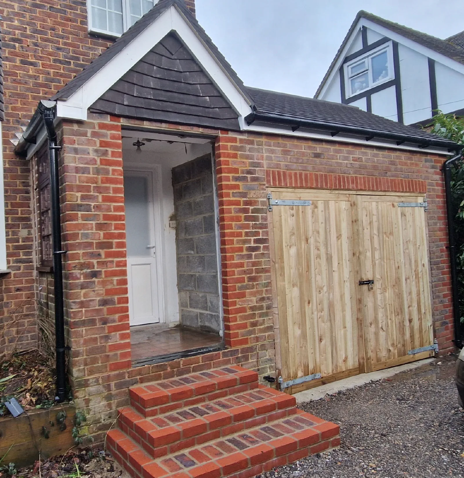 Completed outbuilding entrance and timber doors